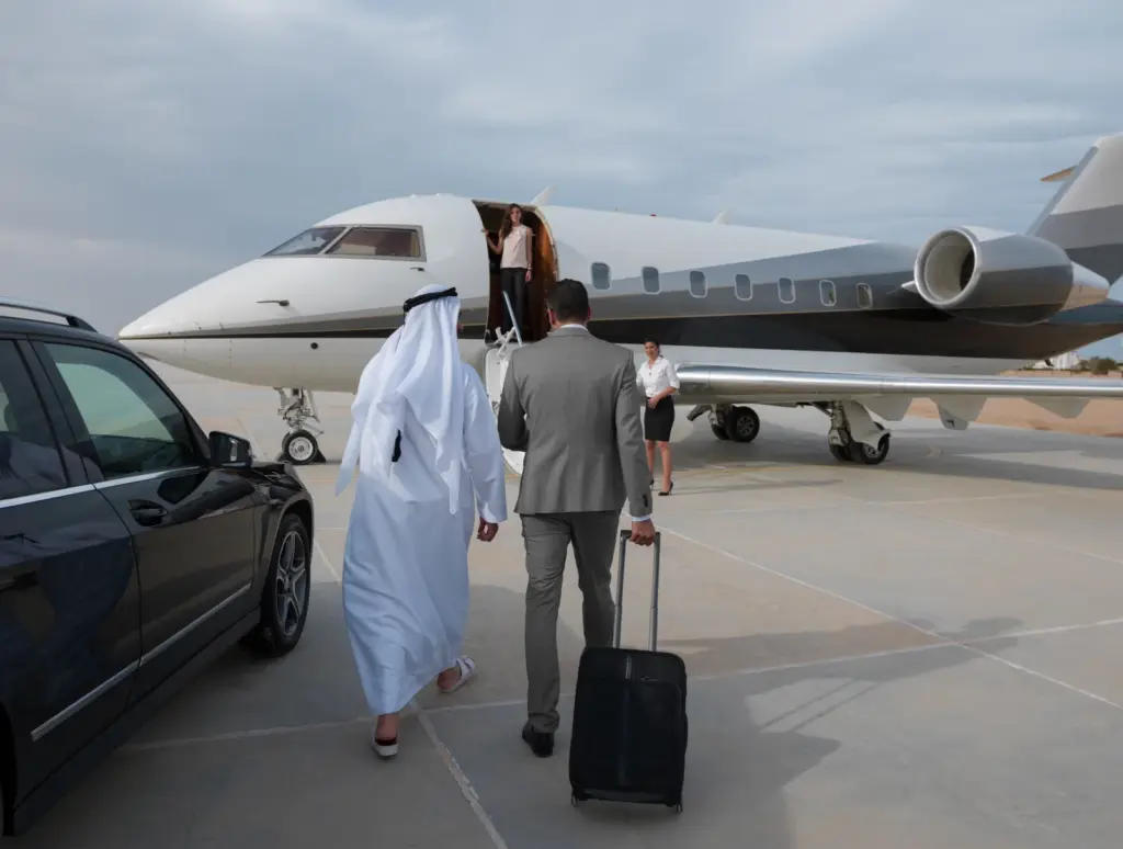 Chauffeur car waiting as travellers board a private jet in the UAE